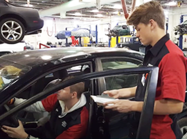 Automotive and Service Technology students working on a car